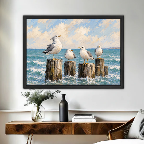 Coastal Gull Gathering Canvas Wall Art framed above a wood console with vases and flowers.