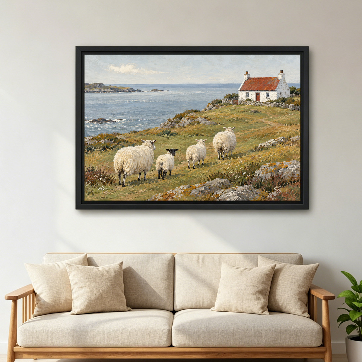 Coastal Sheep Cottage Canvas Wall Art framed above a cream sofa with wooden arms.