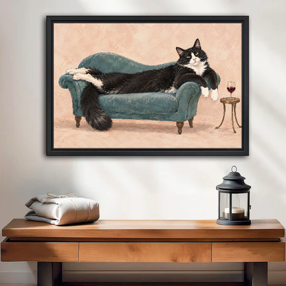 Lounging Tuxedo Cat Canvas Wall Art framed above a wood console with linen and lantern.