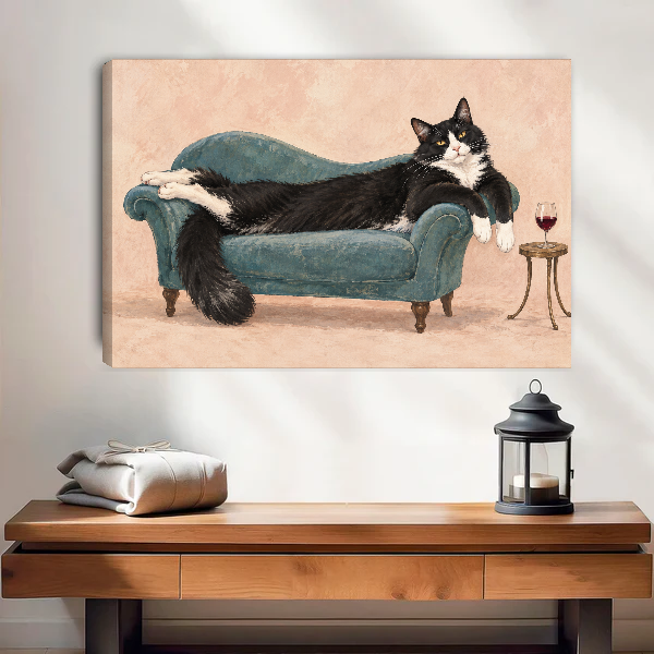 Lounging Tuxedo Cat Canvas Wall Art unframed above a wood console with linen and lantern.