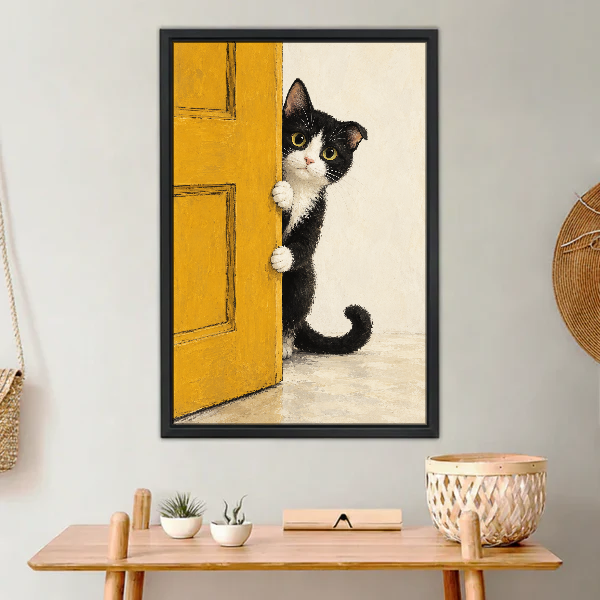 Peekaboo Kitten Canvas Wall Art framed above a light wood console with cacti.