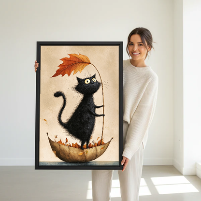 Autumn Leaf Cat Canvas Wall Art held in a black frame by a woman in cream.
