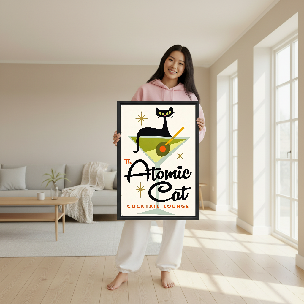Atomic Cat Cocktail Canvas Wall Art held in a black frame by a woman in pink.