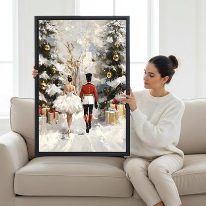 Snowy Nutcracker Walk Canvas Wall Art held by a seated woman beside a cream sofa.