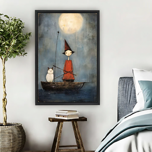 Moonlit Cat Boat Canvas Wall Art framed above pale blue bedding beside books and plants.