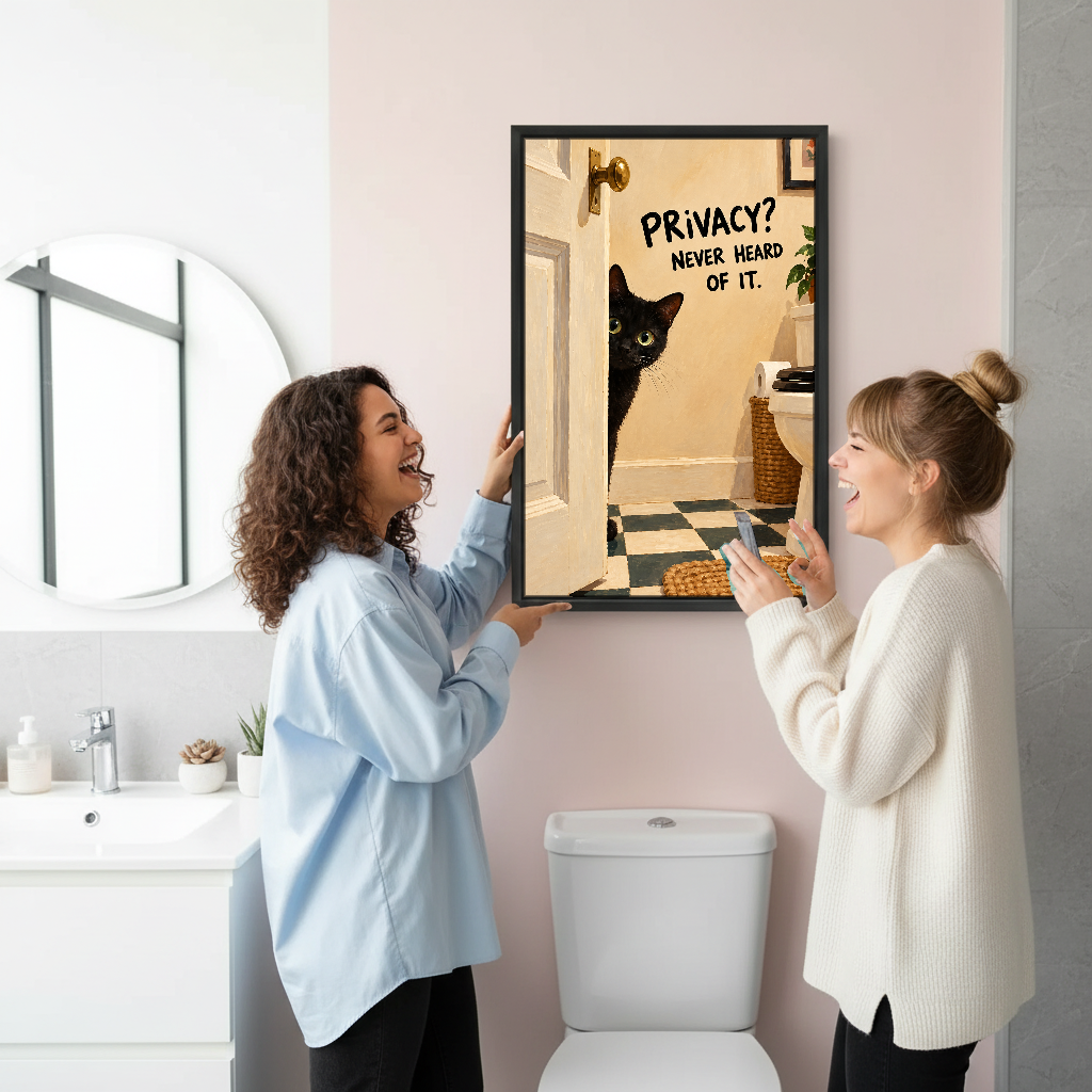 Privacy Cat Bathroom Canvas Wall Art held by two women beside a bathroom mirror and toilet.
