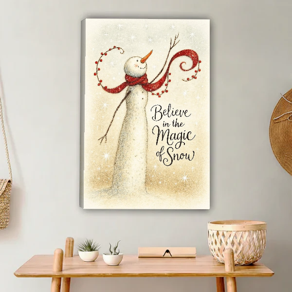 Magic of Snow Snowman Canvas Wall Art unframed above a light wood console and woven basket.