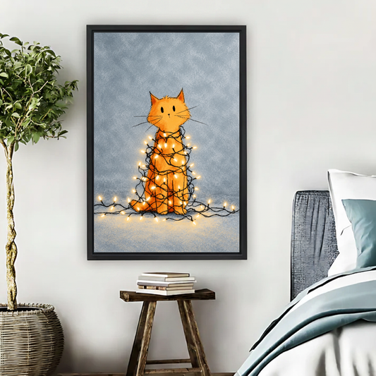Tangled Christmas Cat Canvas Wall Art framed above pale blue bedding beside books and plants.