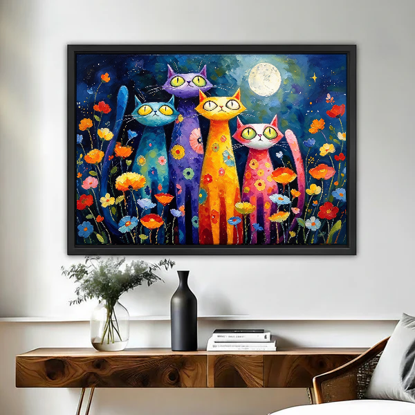 Colorful Night Cats Canvas Wall Art framed above a wood console with black vase and branches.