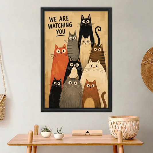 We Are Watching Cats Canvas Wall Art framed above a light wood console with cacti.