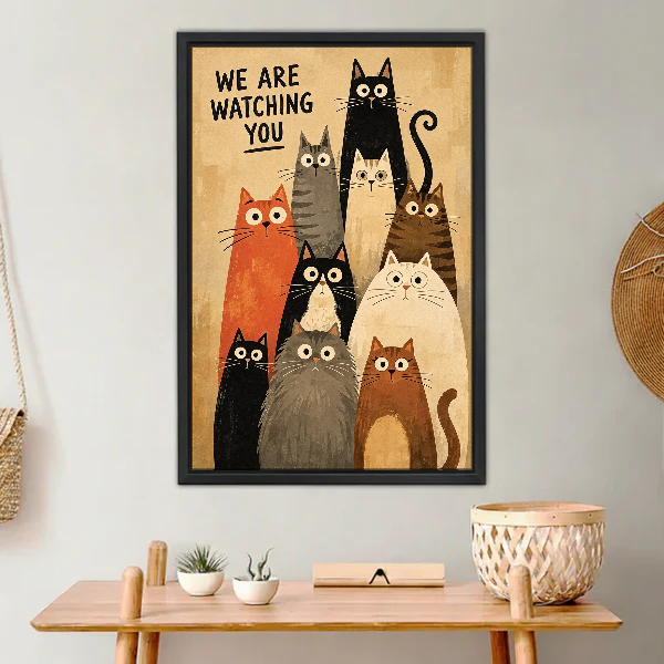 We Are Watching Cats Canvas Wall Art framed above a light wood console with cacti.
