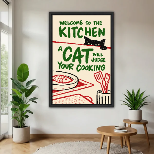 Kitchen Cat Food Critic Canvas Wall Art framed above a pale wood table beside green plants.