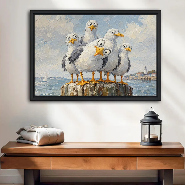 Curious Coastal Gulls Canvas Wall Art framed above a wood console with lantern and folded linen.