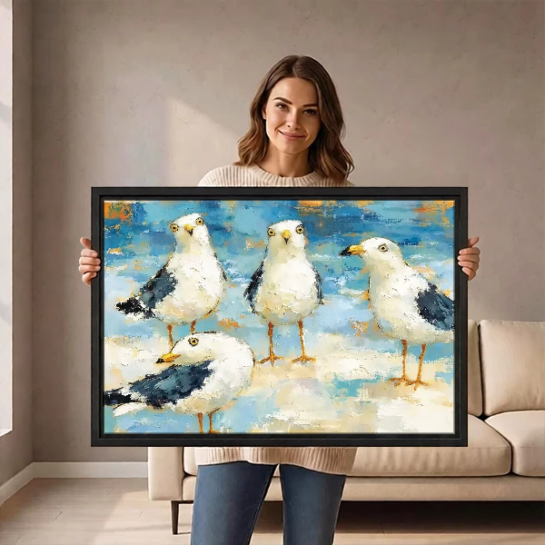 Seaside Gull Gathering Canvas Wall Art held by a woman before a neutral cream sofa.