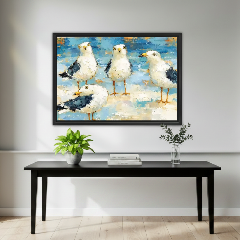 Seaside Gull Gathering Canvas Wall Art framed above a black console with green plants and books.