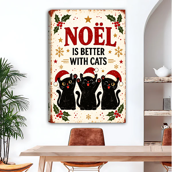 Noel Better With Cats Canvas Wall Art unframed above a wood desk beside a brown chair.