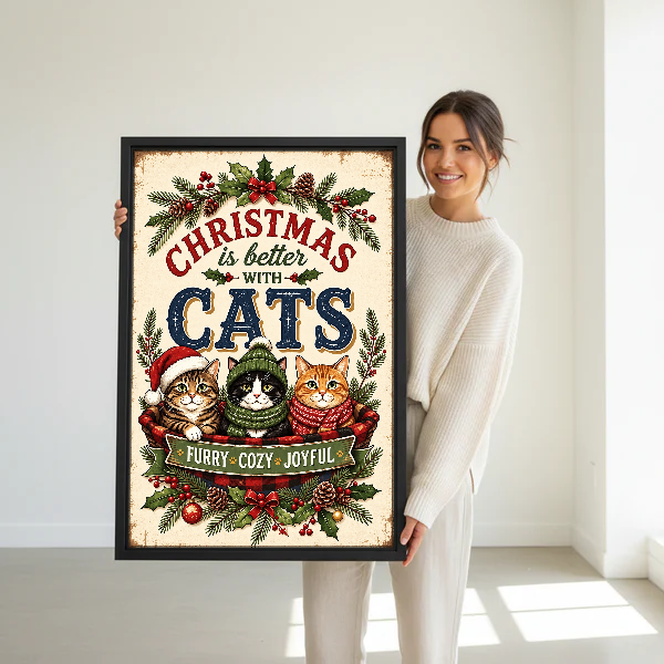 Cozy Christmas Cat Basket Canvas Wall Art held in a black frame by a woman in cream.