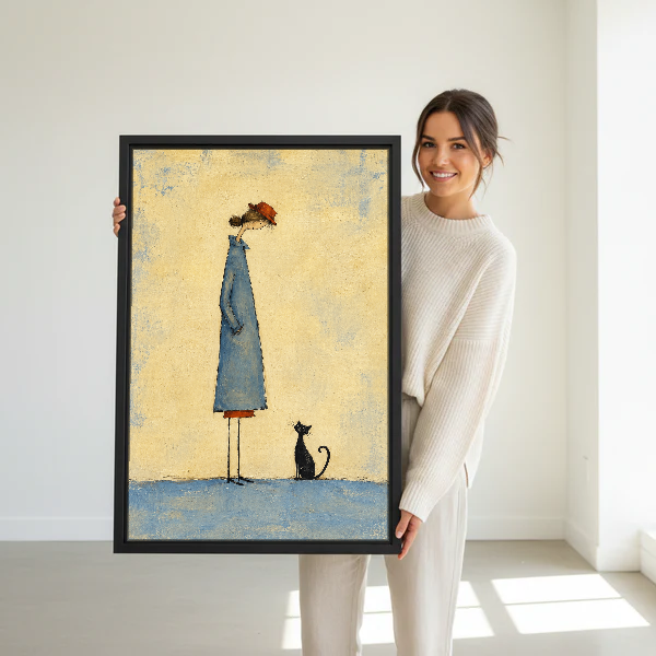 Little Cat Quiet Company Canvas Wall Art held in a black frame by a woman in cream.