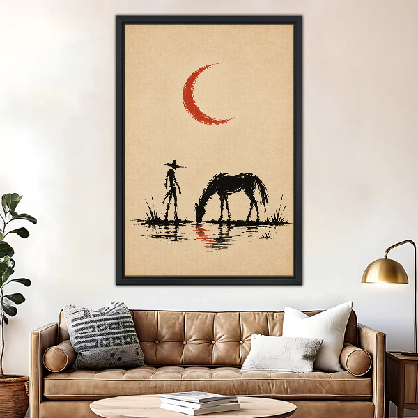Cowboy Horse Red Moon Canvas Wall Art framed above a brown leather sofa and brass lamp.
