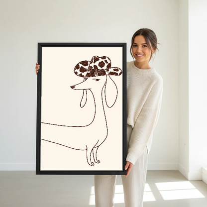Cowboy Hat Dachshund Canvas Wall Art held in a black frame by a woman in cream.