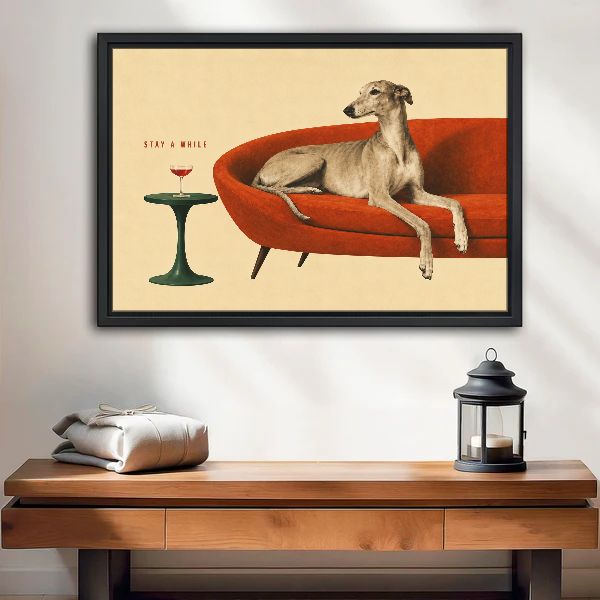 Greyhound Stay A While Canvas Wall Art framed above a wood console with lantern and folded linen.