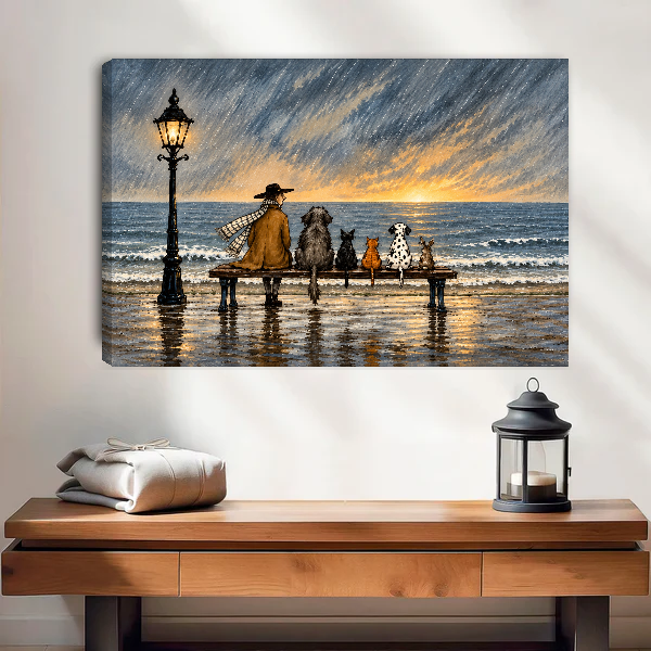 Rainy Seaside Bench Companions Canvas Wall Art unframed above a wood console with lantern and folded linen.