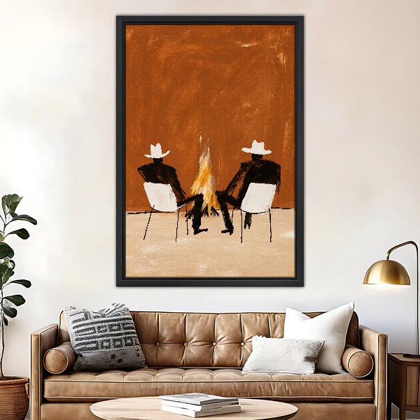 Cowboys By The Campfire Canvas Wall Art framed above a brown leather sofa and brass lamp.