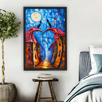 Moonlit Heart Rooftop Cats Canvas Wall Art framed above pale blue bedding beside books and plants.