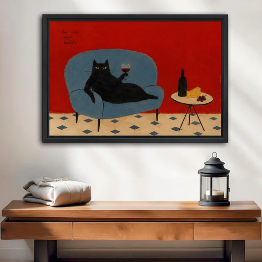 Black cat La Vie Est Belle framed wall art print on console table with lantern, eclectic vintage living room decor