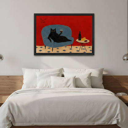La Vie Est Belle black cat wall art print in black frame above modern bedroom bed, bold red vintage canvas decor