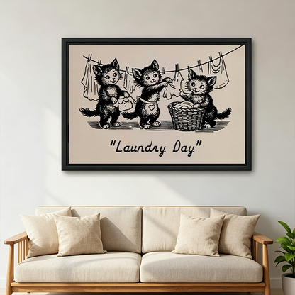 Woman holding framed Laundry Day kittens canvas wall art showing three cats beside a laundry basket and clothesline.
