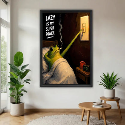 Black-framed lazy frog canvas wall art on a white wall beside plants