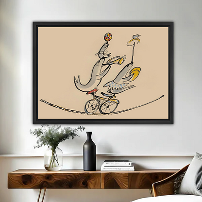 Line art circus fish canvas wall art in black float frame above wooden console, three fish cycling on tightrope with ball and banana, warm sand background