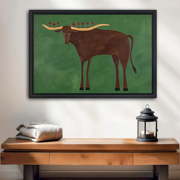 Whimsical longhorn wine glass canvas wall art on green in a black frame above a cream wooden-arm sofa.