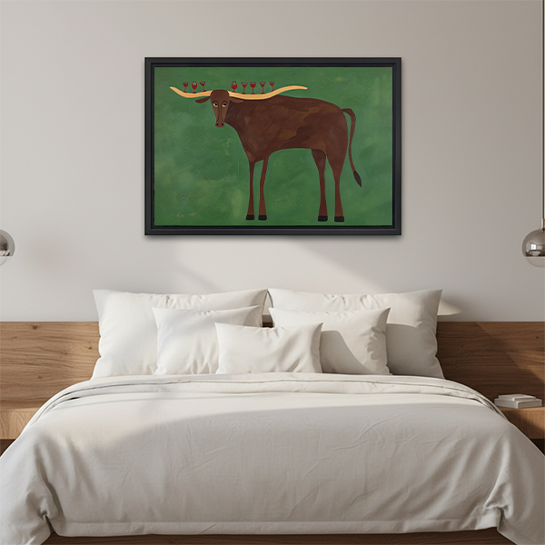 Woman holding black-framed longhorn wine glass canvas wall art depicting a brown longhorn balancing red wine glasses.