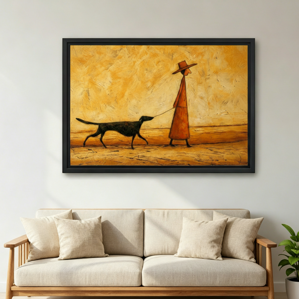 Black framed figurative desert dog walk canvas print hung above a natural linen sofa in a bright Scandinavian living room, featuring a stylized man in an orange coat and hat with a black dog on a golden textured background