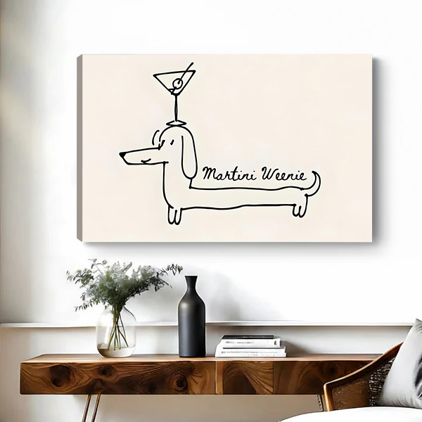 Canvas art print of the Martini Weenie dachshund minimalist line drawing on a beige background, displayed above a wooden console table with greenery