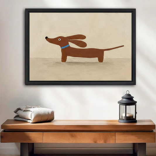 Framed minimalist dachshund wall art print hung above a wooden console table with lantern decor in an entryway