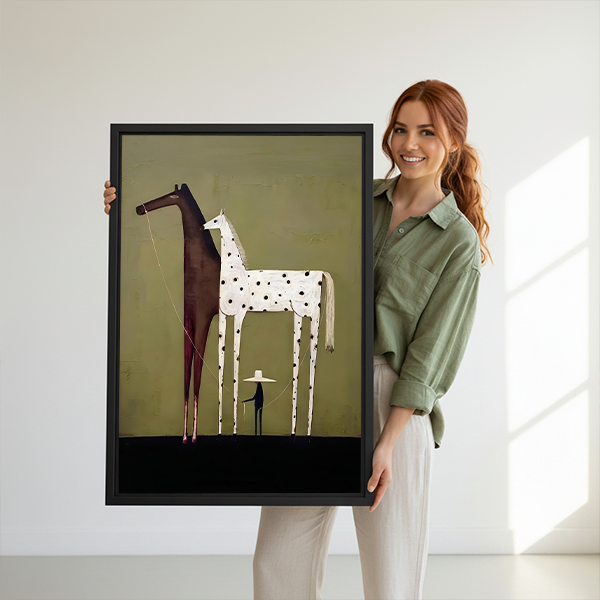 Smiling woman holding large black framed minimalist two horses and figure canvas art print to show scale