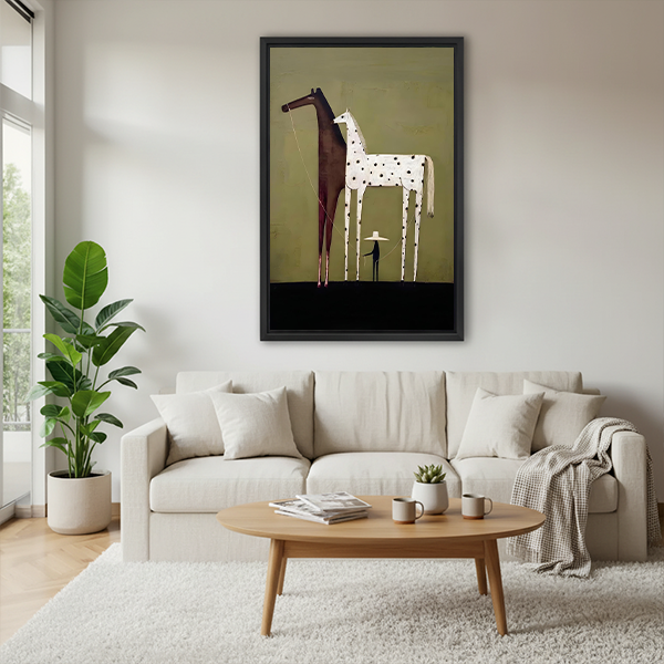 Black framed minimalist two horses canvas wall art hung above a cream sofa in a Scandinavian living room