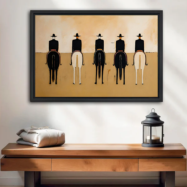 Framed minimalist western horse riders canvas wall art displayed above a wooden console with a lantern