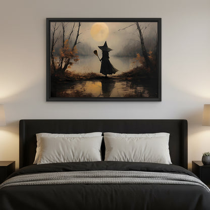 Framed witch silhouette full moon wall art hanging above a black upholstered bed with white pillows
