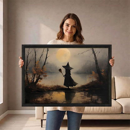 Smiling woman holding framed vintage witch moon canvas wall art in front of a cream sofa