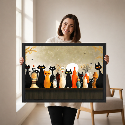 Black-framed moonlit cats canvas wall art displayed above a white bed with pillows and a wooden headboard.