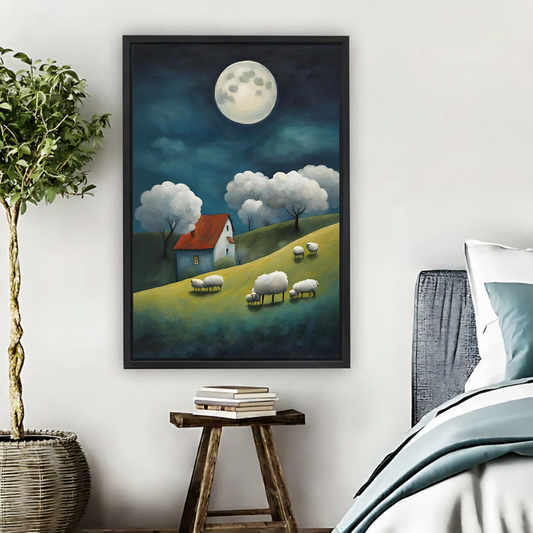 Whimsical moonlit sheep grazing on green hillside with red roof cottage framed canvas print displayed in cozy bedroom