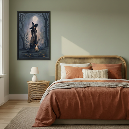 Framed moonlit witch in forest canvas wall art hanging beside a bed with woven headboard.