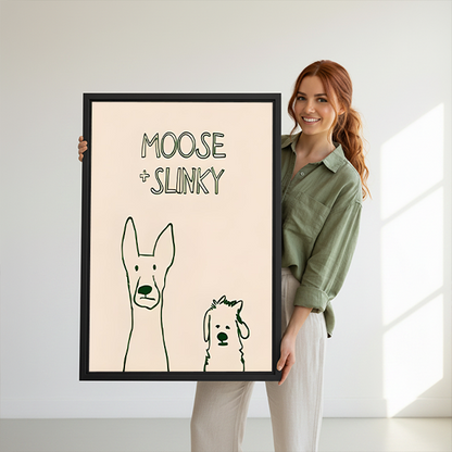 Woman holding framed Moose and Slinky dog canvas wall art with two playful line-drawn dogs.