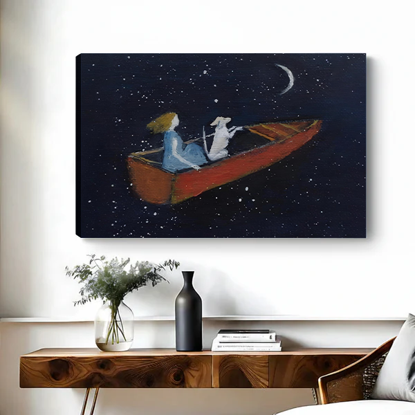 Canvas art print of a girl and dog sailing through a starry night sky in a red boat, displayed above a rustic wooden console table