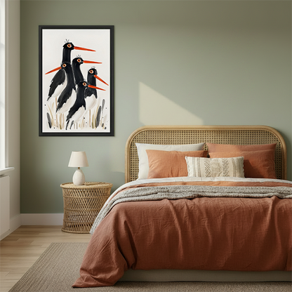 Framed oystercatcher bird watercolor print displayed above a rattan bed headboard in a sage green bedroom