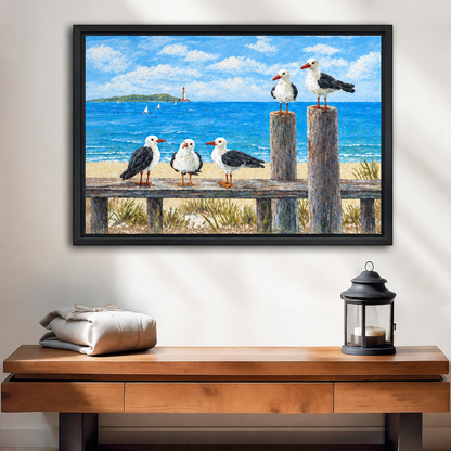 Black-framed painterly coastal seagull canvas wall art above a wooden console with folded linens and a lantern.